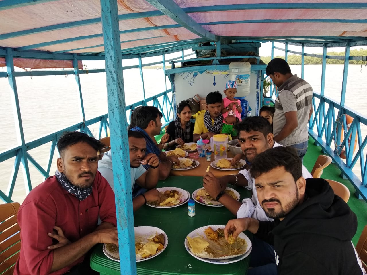 People eating food on boat in Sunderban